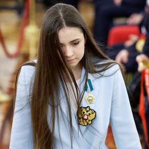 Kamila Valieva walks during a meeting with Vladimir Putin.