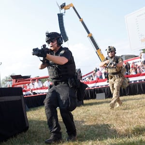 Law enforcement officers move following a shooting during a rally held by Donald Trump in Butler, Pennsylvania.