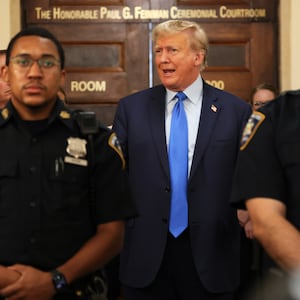 Former US President Donald Trump speaks while the court takes a lunch recess during the first day of his civil fraud trial at New York State Supreme Court