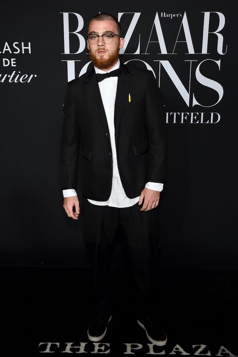 Angus Cloud attends an event in a modern black tuxedo.