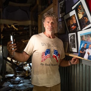 Actor John Schneider, known for his role as Bo Duke in \"The Dukes of Hazzard\" television series, stands inside his studio that was damaged by Hurricane Ida on September 2, 2021 in Holden, Louisiana