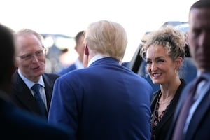 Donald Trump, speaks with David Limp, left, and Megan Mitchell, right in Austin, Texas.