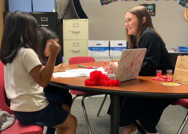 Teacher Katherine Rinderle working in her classroom with students