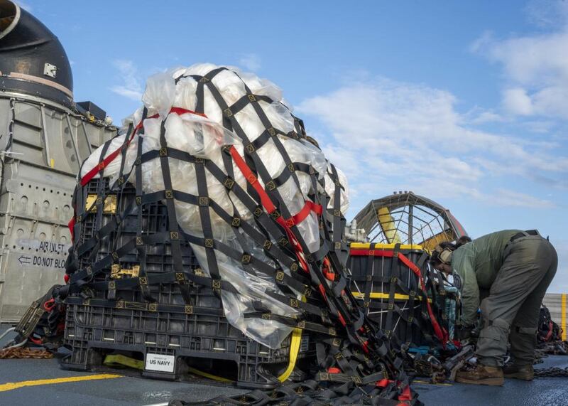 U.S. Navy personnel on Friday securing and transporting the remnants of a Chinese spy balloon