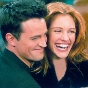 Matthew Perry and Julia Roberts hug on the set of "Friends"