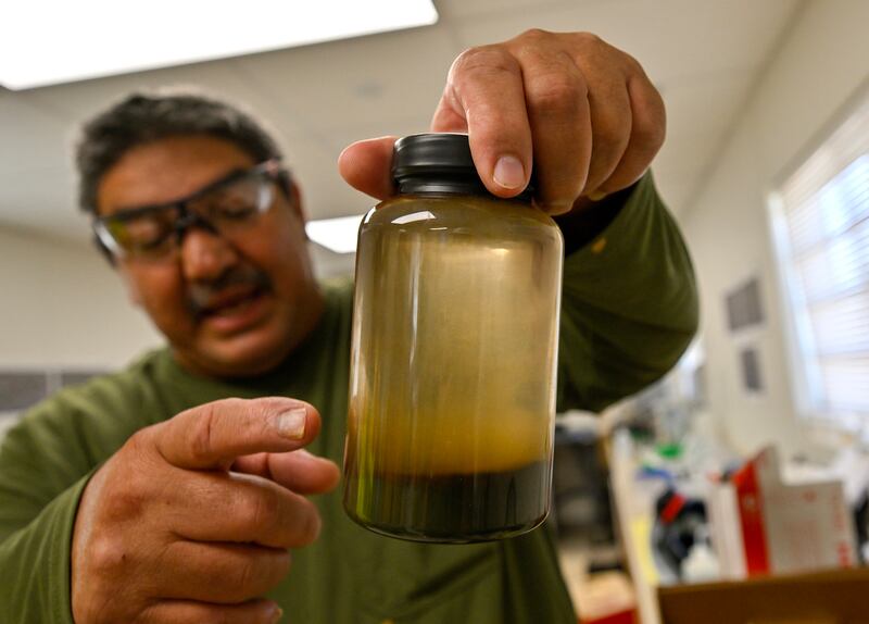 Emir Salas, lead chemist at Controlled Thermal Sources, shows off brine with metals extracted.