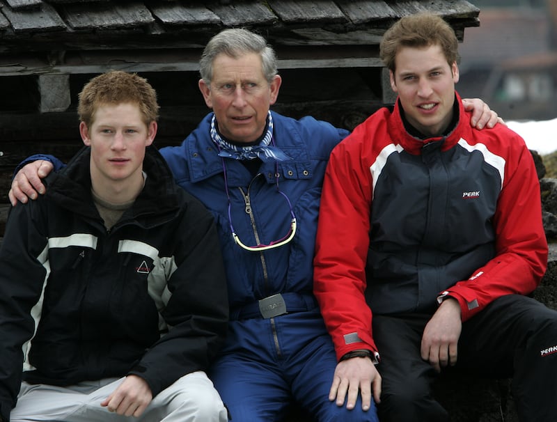 Then-Prince Charles, center, and his sons Prince Harry, left, and Prince William, right, pose for photographs in Klosters, March 31, 2005.