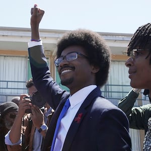 Justin J. Pearson gestures as he marches with supporters from the National Civil Rights Museum to the Shelby County Commission