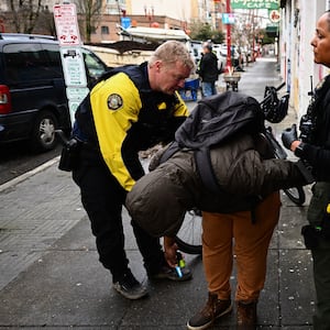 Two officers arrest a man in downtown Portland. 