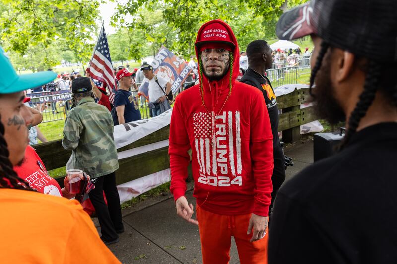 Supporters of former President Donald Trump gather at the entrance of the Trump campaign rally.