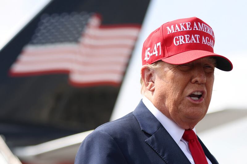 Former President Donald Trump speaks as he arrives at Hartsfield-Jackson Atlanta International Airport.