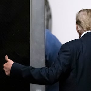 Former U.S. President Donald Trump gestures as he leaves court during his hush money trial.