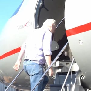 Julian Assange boarding a plane and departing the U.K. after striking a deal with U.S. prosecutors.