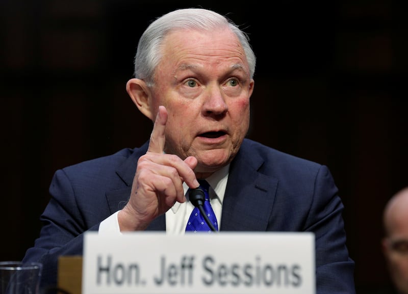 Jeff Sessions at a Senate committee hearing with his finger in the air