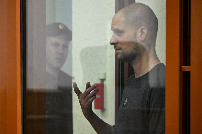 Wall Street Journal journalist Evan Gershkovich, who is currently jailed in Russia on espionage charges, gestures inside a glass defendants' cage during his verdict announcement.