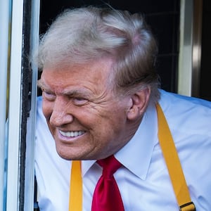 Former president Donald Trump hands out food from a McDonald's drive-thru window in Feasterville-Trevose, PA