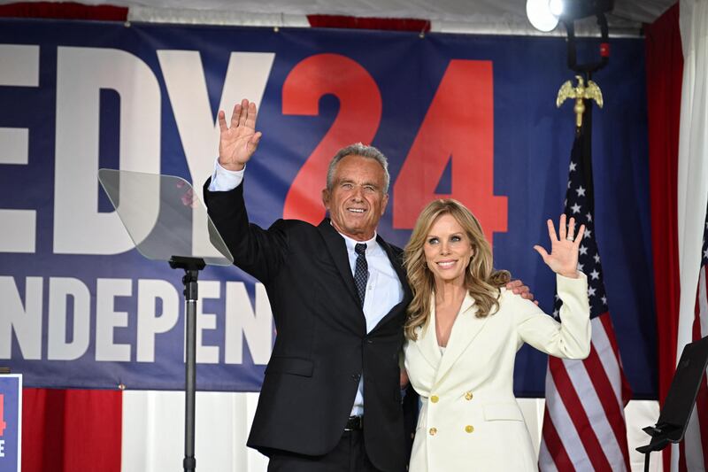 Robert F. Kennedy Jr. and Cheryl Hines wave to supporters after he announced his entry to the 2024 presidential race as an independent candidate.