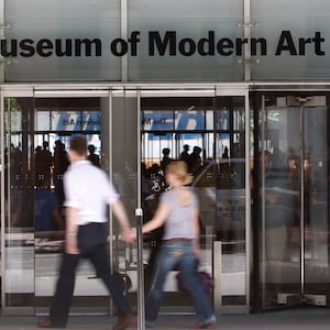 Entrance to the Museum of Modern Art with people walking in front.