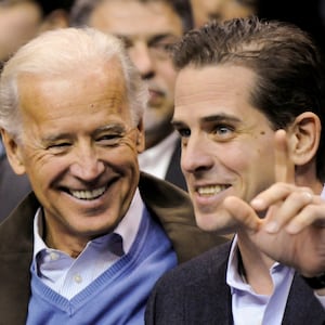 Then-U.S. Vice President Joe Biden and his son, Hunter Biden,  attend an NCAA basketball game between Georgetown University and Duke University in Washington, U.S., January 30, 2010.