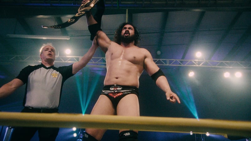 Mahabali Shera raising a title belt in 'Wrestlers'