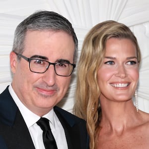 John Oliver and Kate Norley pose for a photo on the red carpet.