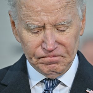 A close up photo of Joe Biden looking down and sad