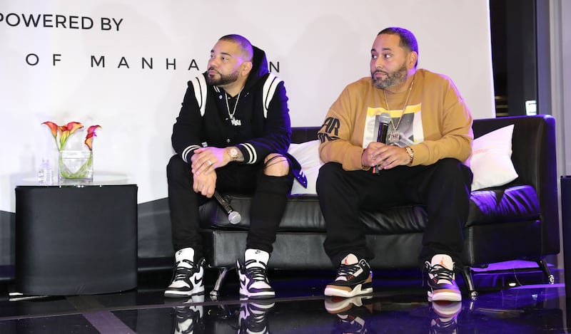 DJ Envy and Cesar Piña on a couch.