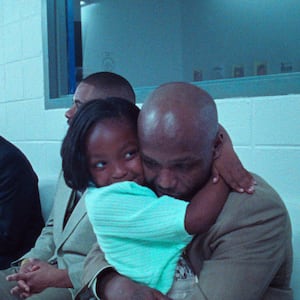 A still of a father and daughter hugging in the film 'Daughters'