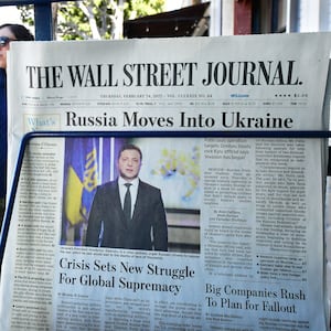 A copy of The Wall Street Journal on a newsstand.