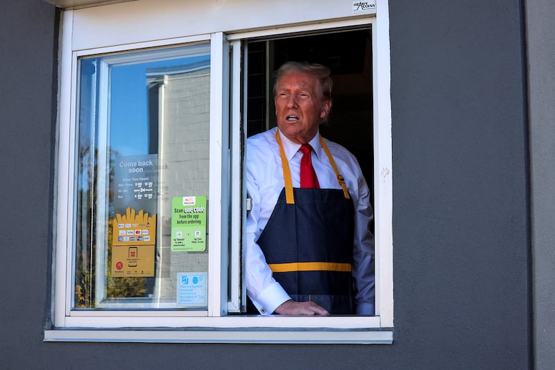 Republican presidential candidate and former President Donald Trump reacts as he serves food at a McDonald's restaurant in Feasterville-Trevose, Pennsylvania, on October 20, 2024.