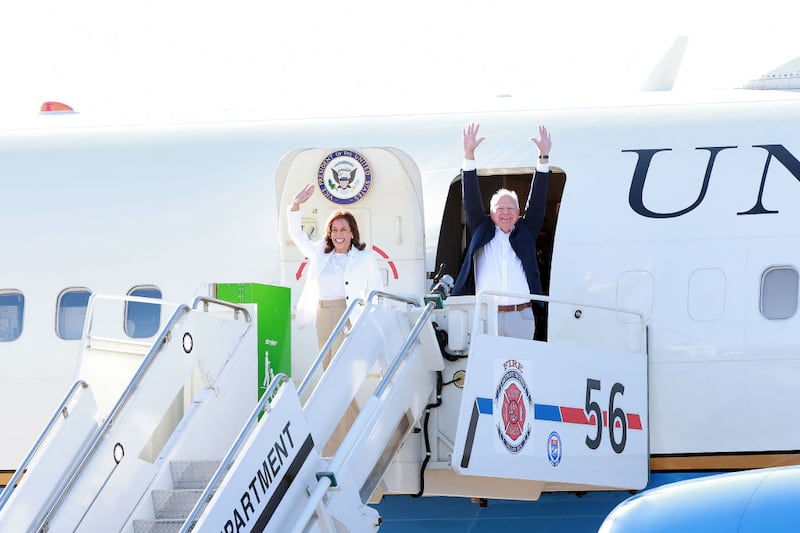 Vice President Kamala Harris and Minnesota Gov. Tim Walz arrive at the Detroit Metropolitan Airport in Romulus, Michigan. 