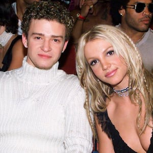 Justin Timberlake and Britney Spears smile in their seats at the 2000 MTV Video Music Awards