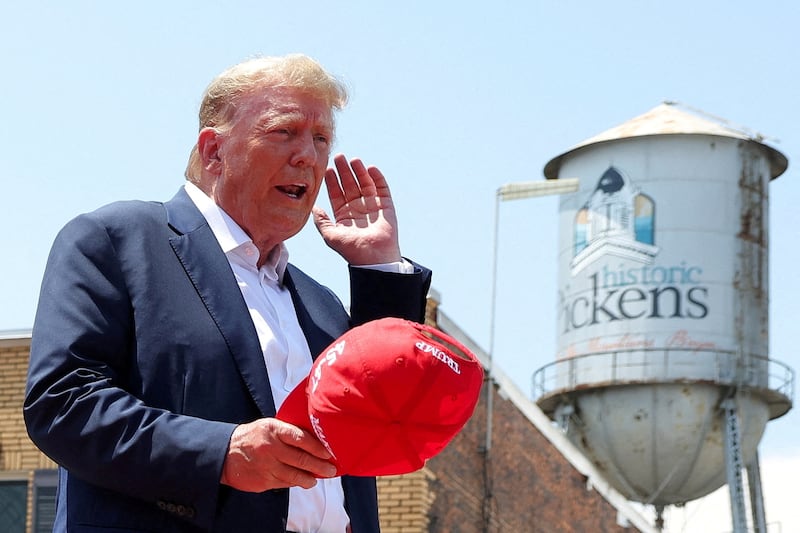 Former President Donald Trump gestures on the day of his "Make America Great Again" rally in Pickens, South Carolina