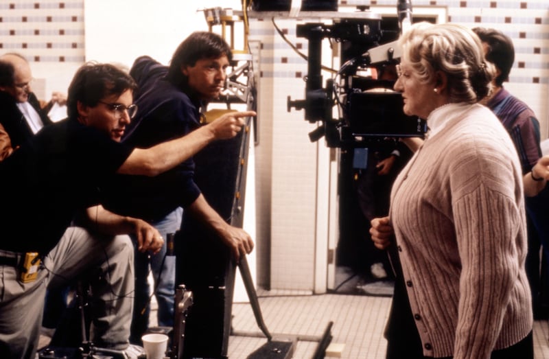 Director Chris Columbus gives instructions to Robin Williams in a behind the scenes photo from ‘Mrs. Doubtfire’