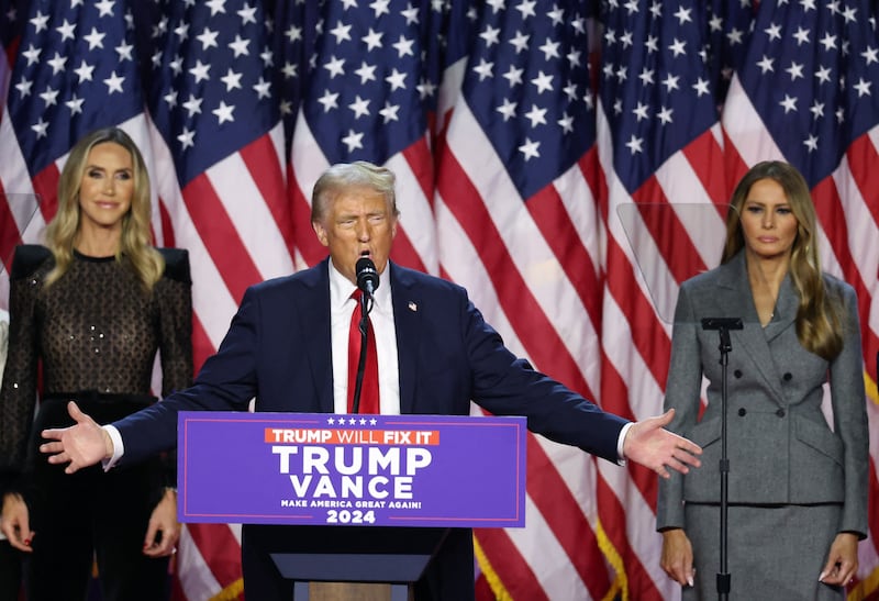 Donald Trump, center, is flanked by Melania Trump and Lara Trump, Nov. 6, 2024.