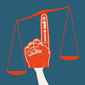 Illustration of an adapted and weighted scales of justice using a #1 MAGA fan foam finger to balance on