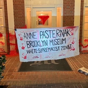 A banner hangs outside the home of Brooklyn Museum director Anne Pasternak.