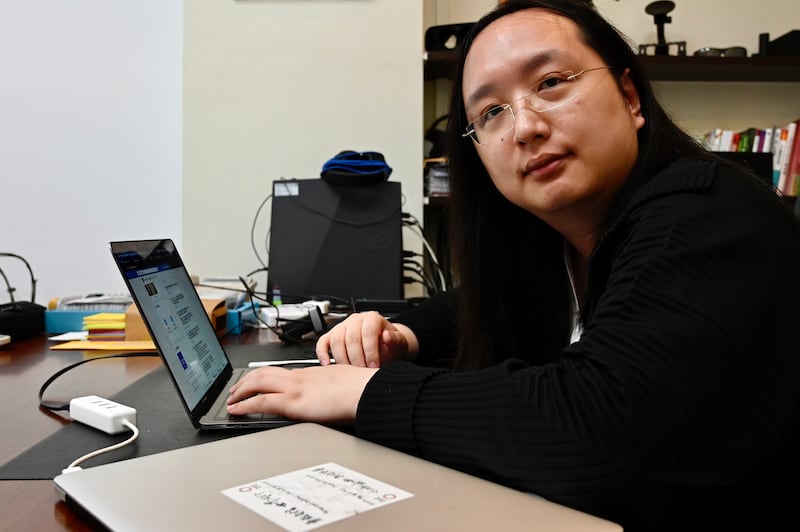 Taiwan's digital minister Audrey Tang sits in front of a laptop