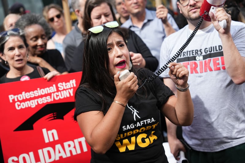 Jessica Ramos speaks into a megaphone during a street protest.