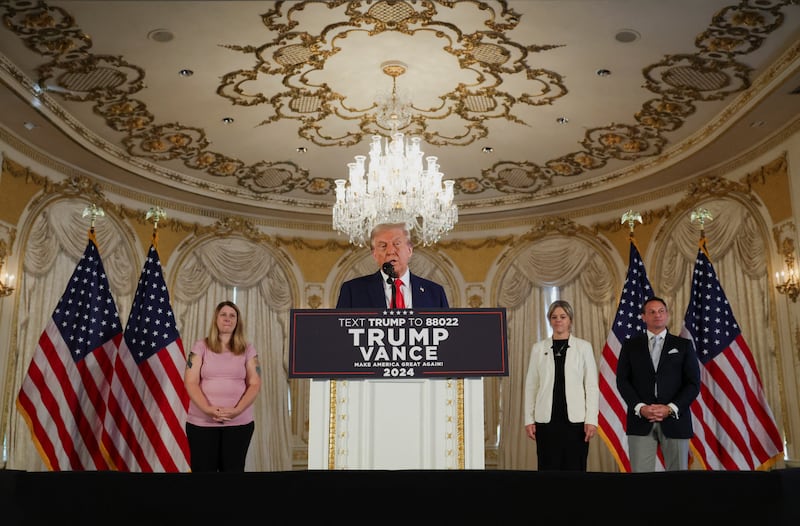 Donald Trump speaks inside Mar-a-Lago at a podium.