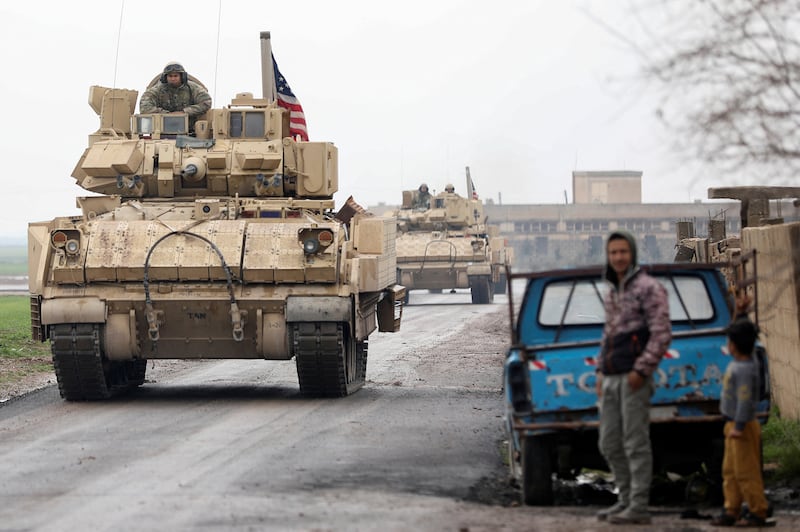 A joint U.S.-Kurdish-led Syrian Democratic Forces (SDF) patrol in the countryside of Qamishli, in northeastern Syria on Feb. 8, 2024.