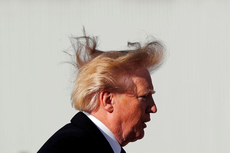 Then-President Donald Trump’s hair has an adverse reaction to the wind as he boards Air Force One.