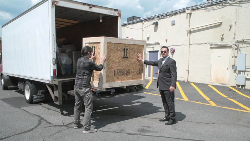 A still from the season finale of How To With John Wilson showing people shipping an organ.