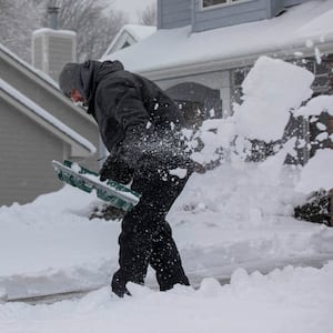 A man shovels snow.