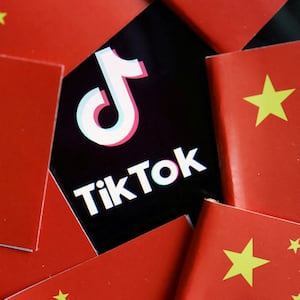 China’s flags are seen near a TikTok logo in this illustration picture taken July 16, 2020. 