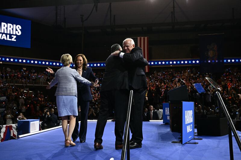 Tim Walz is greeted by Doug Emhoff with a big bear hug on Aug. 6. 