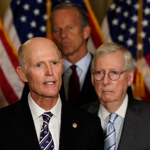 Senator Rick Scott (R-FL) speaks to reporters as Senators Joni Ernst (R-IA), John Thune (R-SD) and Senate Minority Leader Mitch McConnell (R-KY) listen at the U.S. Capitol in Washington.