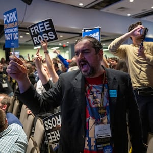 A Libertarian party member shouts protests as former US President and Republican presidential candidate Donald Trump addresses the Libertarian National Convention in Washington, DC, May 25, 2024.