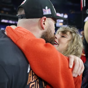 Travis Kelce of the Kansas City Chiefs celebrates with his girlfriend, Taylor Swift, after a 17-10 victory against the Baltimore Ravens in the AFC Championship Game.