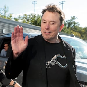 Elon Musk waves as he attends the men's final on day fourteen of the 2024 US Open Tennis Championships 